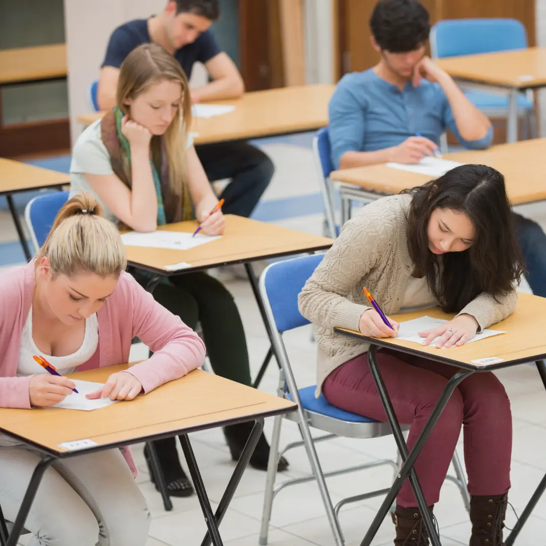 A group of students sitting in an exam hall