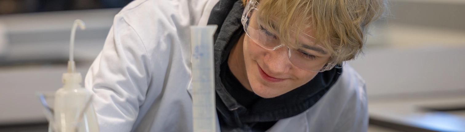 Applied Science student uses a test tube at MidKent College