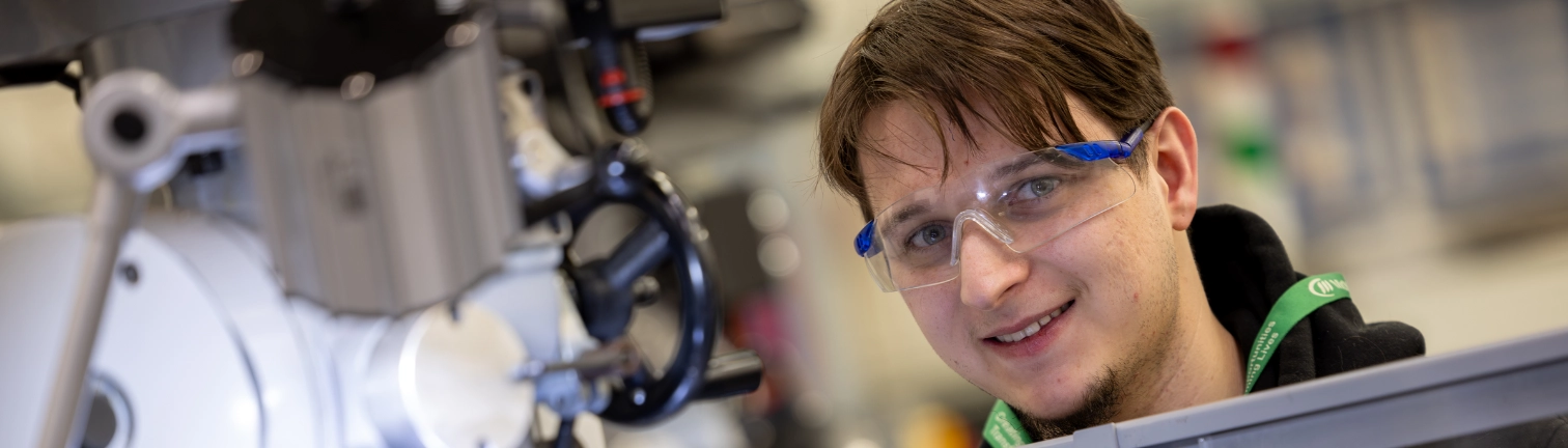 Engineering student working on a piece of metal