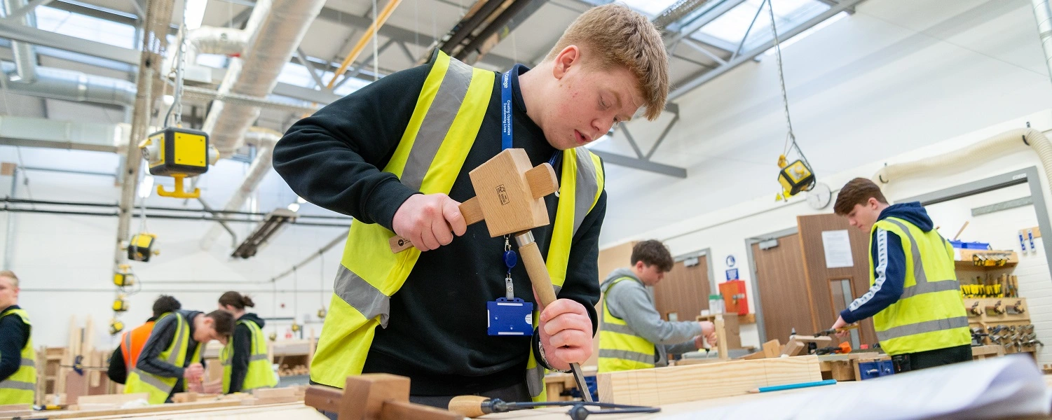 Carpentry student uses handtools