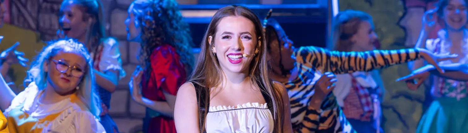 Preforming arts student in panto smiling at the camera