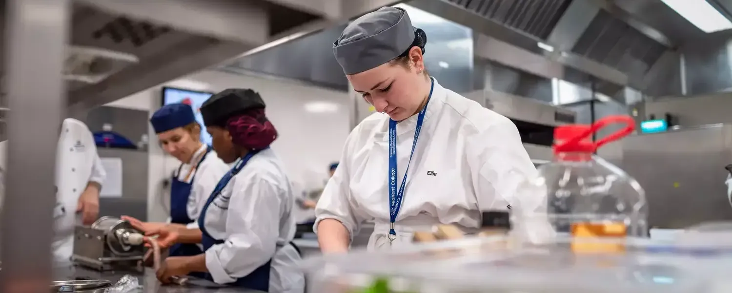 Catering students preparing food in the training kitchen