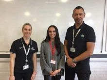 Tutors and student smile at the camera