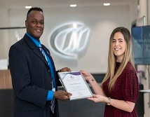 Laura receiving a certificate from Carl