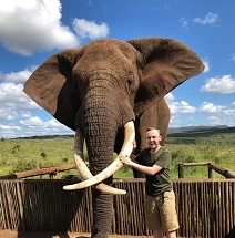 Man standing next to Elephant