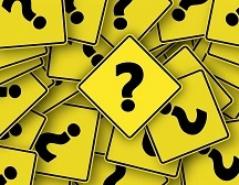 Black and yellow question marks in a pile